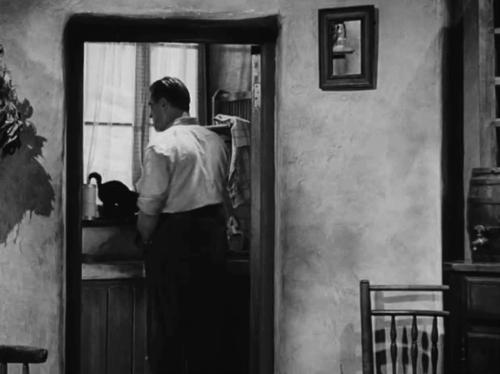Against the Wind - Max Jack Warner shaving with black cat on windowsill in background animated gif