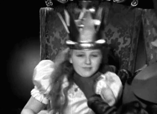 Alice in Wonderland - Alice Charlotte Henry being throttled then waking up with longhair calico cat Dinah in chair animated gif