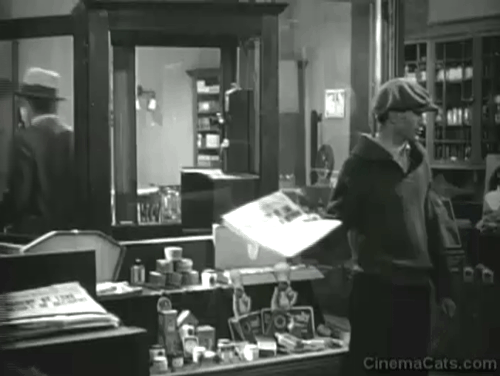 An American Tragedy - black cat climbing over back of counter behind newsboy and Clyde Griffiths Phillips Holmes animated gif