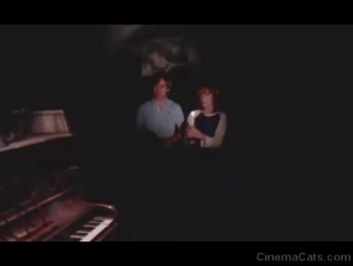 Antropophagus - tabby kitten dropping down on piano keys scaring Julie Tisa Farrow and Daniel Mark Bodin animated gif