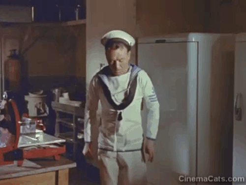 The Baby and the Battleship - Puncher John Mills tossing black cat drinking milk away from saucer animated gif