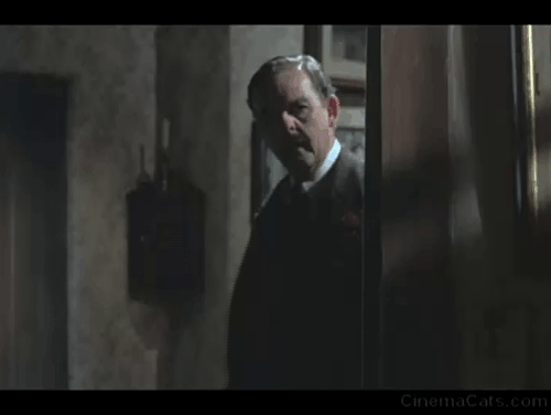 Bedknobs and Broomsticks - ragged black cat Cosmic Creepers on mantel hissing angrily animated gif