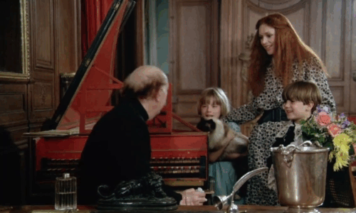 La bête - longhair Snowshoe patterened cat trying to wriggle out of arms of Marie Testanière with Clarisse Pascale Rivault, Stéphane and priest Roland Armontel animated gif