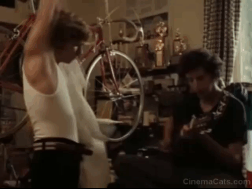 Breaking Away - tabby cat Fellini Jake jumping from bed and running away when Cyril Daniel Stern strums guitar animated gif