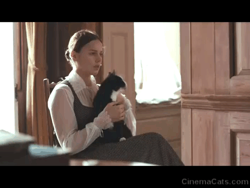 Bright Star - Fanny Abbie Cornish sitting with tuxedo cat Topper who jumps down from her lap animated gif