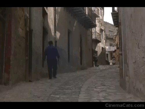 The Brotherhood - man on scooter riding through Sicilian street startling black cat animated gif