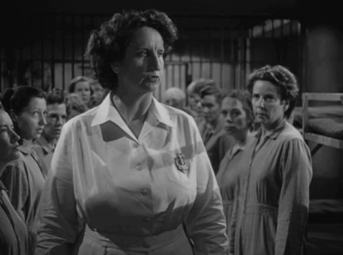 Caged - Marie Allen Eleanor Parker defiantly holding tiny tabby kitten Fluff as matron Hope Emerson advances animated gif