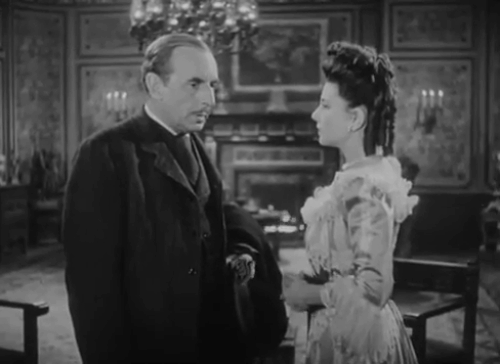 The Catman of Paris - Marie Lenore Aubert and Audet Francis Pierlot startled by shadow of cat on wall cast by longhair calico cat on table animated gif