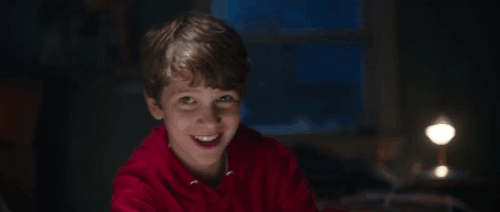 Child's Play - Andy Gabriel Bateman reaching down to pick up card character next to ginger tabby cat Mickey Rooney who scratches him startling Chucky animated gif