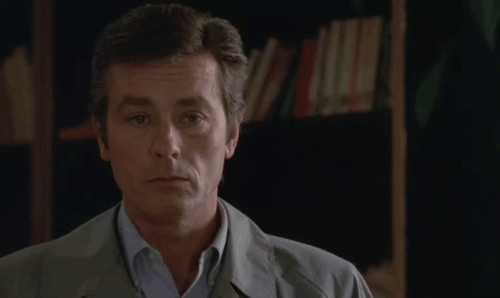 Le Choc - The Shock - Terrier Christian Alain Delon throwing knife into forehead of Boro Feodor Atkin when distracted by gray cat Soudan animated gif