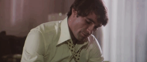 Il Commissario Verrazzano - Luc Merenda feeding gray tabby cat Ciro animated gif