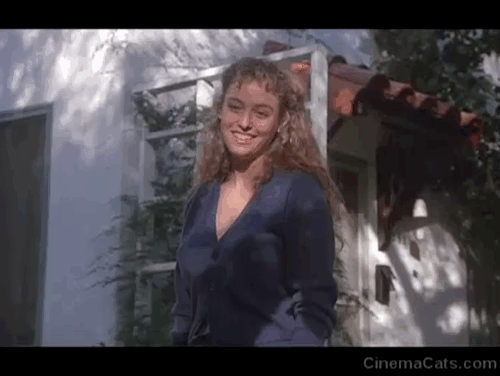 Creator - Barbara Virginia Madsen watching white cat Penelope and orange and white cat Ulysses jumping on mini fridge carried by Boris Vincent Spano with animated gif