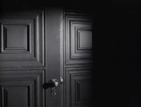 The Creeper - Nora Janis Wilson looking worried as black cat with white paw Creeper runs through house and stops at door animated gif