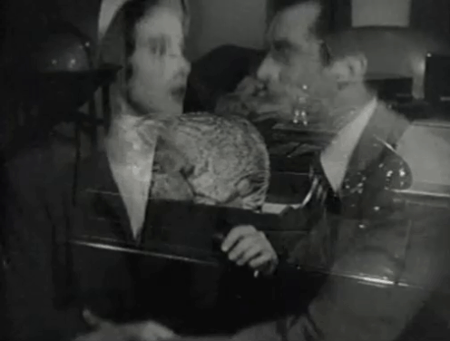 The Creeper - Nora Janis Wilson answering phone as tabby cat jumps off desk and is picked up by Andre David Hoffman animated gif