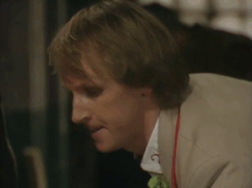 Doctor Who - Resurrection of the Daleks, Part One - Peter Davison moving empty cloth bags to reveal tabby and white cat animated gif