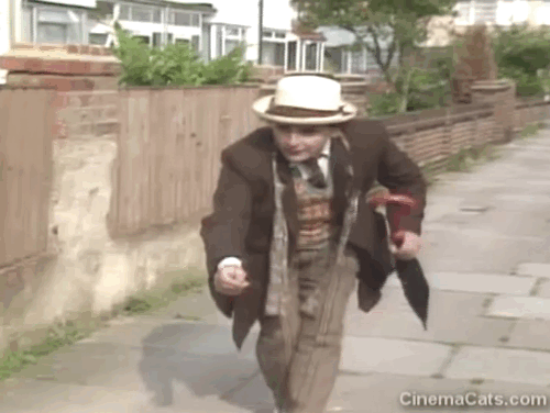 Doctor Who - Survival - Dr. Who Sylvester McCoy reaching for black cat Kitling before being pulled back by Patterson Julian Holloway animated gif