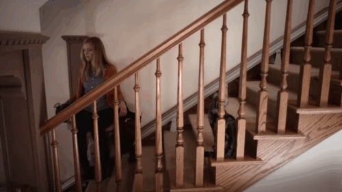 Don't Trust the B---- in Apartment 23 - It's a Miracle - June Dreama Walker riding stairlift chair up stairs as Michael Landes comes down stairs with tabby cat Freckles watching animated gif