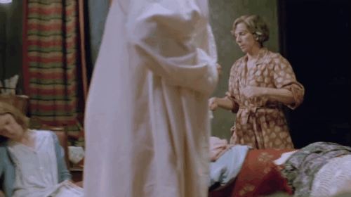 The Dressmaker - black cat scared off chair as Margo Billie Whitelaw pours water onto fire animated gif