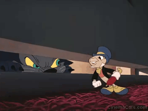 Fun & Fancy Free - Jiminy Cricket barks at and scares black cat under door animated gif