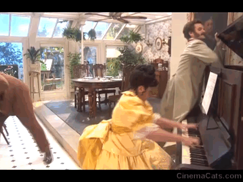 The Goes Wrong Show - Harper's Locket - Bernard Robert Henry Lewis throwing fake white Persian cat at piano with Edwin Chris Henry Shields and Emily Annie Nancy Zamit animated gif
