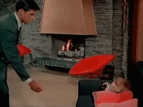 The Green Hornet - Progammed for Death - Britt Reid Van Williams holding transmitter towards Siamese cat on couch who runs away animated gif