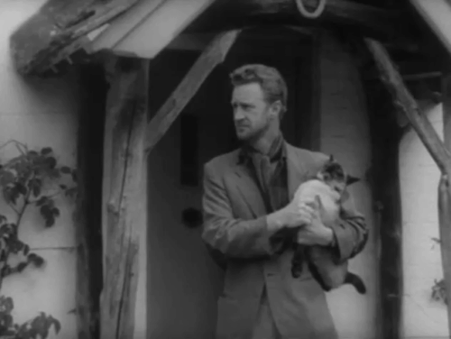 The House in the Woods - Geoffrey Michael Gough with Spencer Ronald Howard holding squirming seal point Siamese cat Cleopatra under arm animated gif