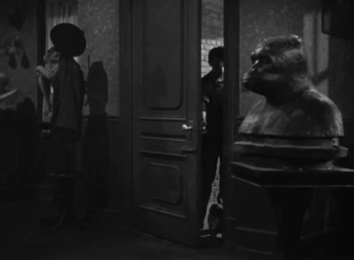 House of Horrors - Marcel Martin Kosleck entering home with grey tabby cat Pietro following animated gif