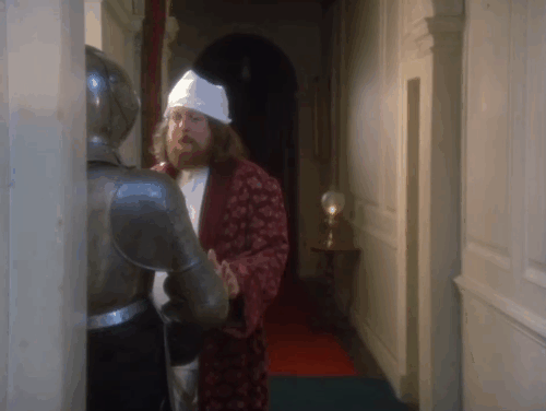 Keep it Up Downstairs - Snotty Shuttleworth William Rushton lifting visor on suit of armor to reveal face of white cat animated gif