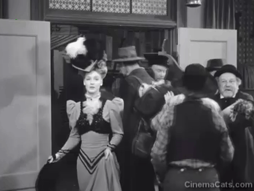 Klondike Kate - Ann Savage entering saloon with Judge Crossit George Cleveland holding small tabby cat Mr. Blackstone burying face in arm animated gif