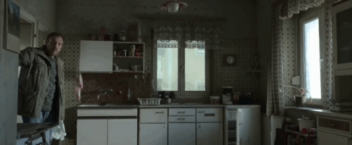 Life Eternal - Das ewige Leben - Brenner Josef Hader sees tuxedo cat Erika sitting on chair then running up stairs animated gif