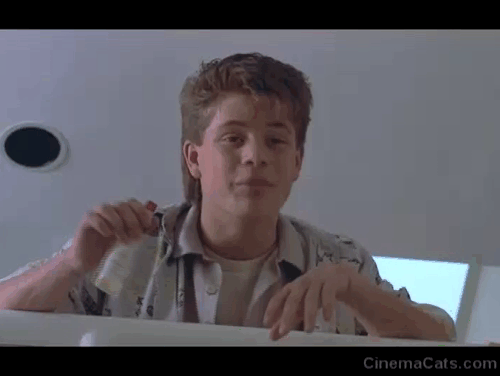 Like Father, Like Son - Trigger Sean Astin showing Tabasco bottle at calico cat Seymour animated gif