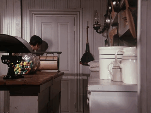 Little House on the Prairie - Gambini, the Great - Willie Jonathan Gilbert approaching black cat Pepper in mercantile animated gif