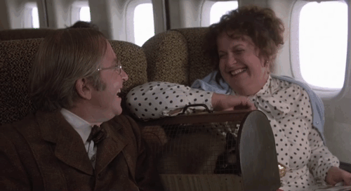 Love at First Bite - Renfield Arte Johnson hissing with woman on plane Jacque Lynn Colton and Siamese cat Salome in carrier animated gif