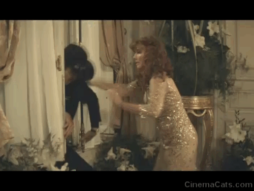 The Love Punch - Kate Emma Thompson and Richard Pierce Brosnan enter a room full of cats and flowers animated gif