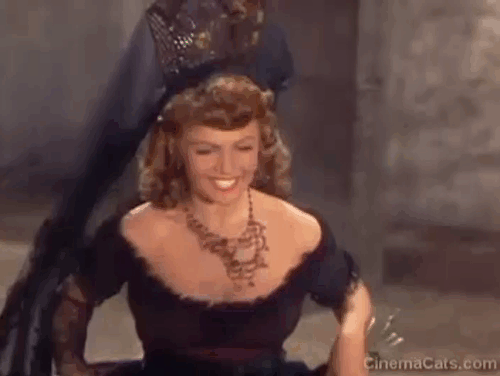 The Loves of Carmen - black cat coming down stairs in front of Carmen Rita Hayworth animated gif