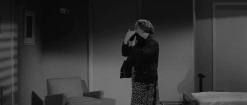 The Man Who Died Twice - black cat carried by Sally Jesslyn Fax who stops to drink from bottle animated gif