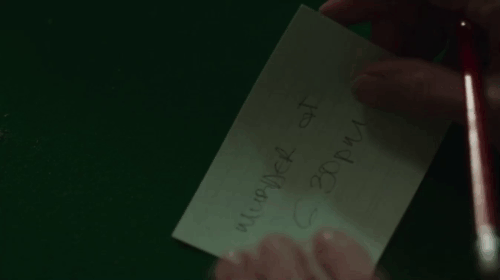 The Marlow Murder Club - Season One - gray longhair cat Jasper Thor turning to look in reverse as Judith sorts cards animated gif