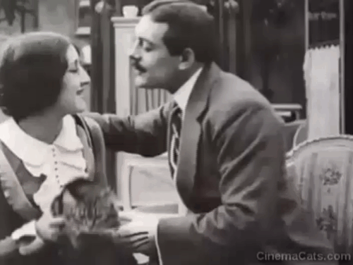 Max Doesn't Like Cats - Max Linder trying to kiss Lucy d'Orbel with longhair tabby cat between them animated gif