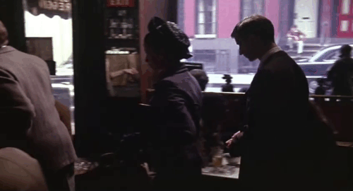 Next Stop, Greenwich Village - Anita Lois Smith holding white and black cat in coffee shop with Larry Lenny Baker, Sarah Ellen Greene and Robert Christopher Walken animated gif