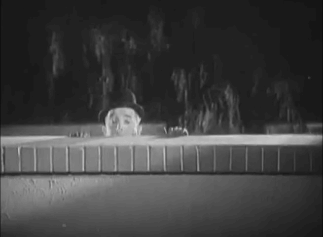 Night Owls - Stan Laurel being scared by cat running along wall animated gif