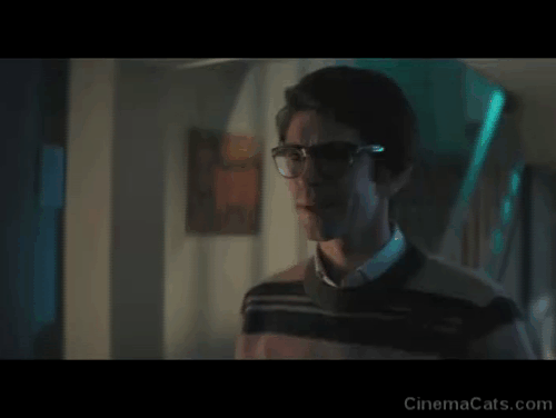 No Time to Die - Q Ben Whishaw picking up hairless Sphynx cat at his feet and placing it on stairs animated gif