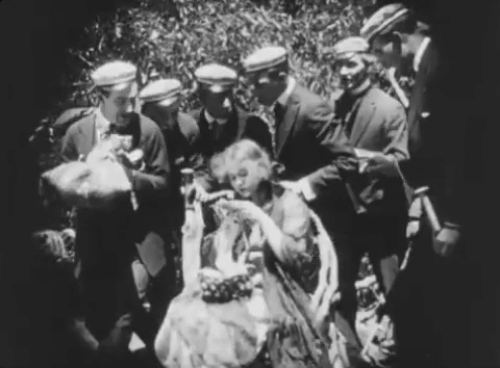 Ole Heidelberg - Katie Dorothy Gish presented a tabby kitten on a pillow by male students animated gif