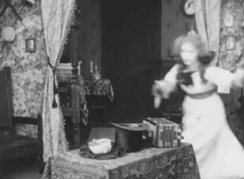 Ole Heidelberg - Katie Dorothy Gish placing tabby kitten inside top hat animated gif