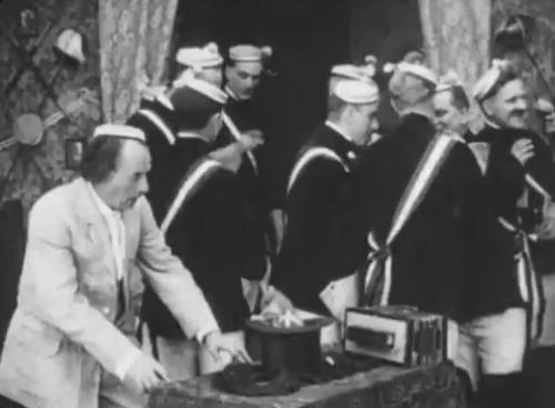 Ole Heidelberg - drunk students spot tabby kitten inside top hat animated gif