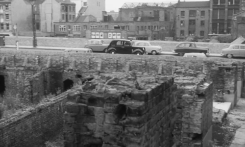 Passport to Shame - Room 43 - black and white cat running away from wall as taxi turns into demolished street animated gif