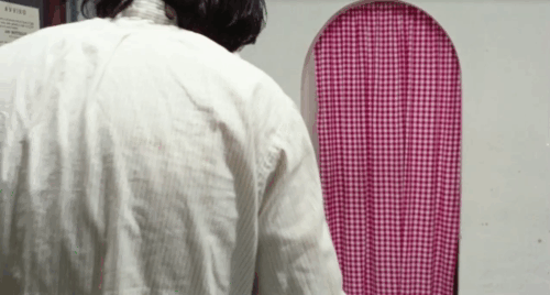 The Police Are Blundering in the Dark - La polizia brancola nel buio - man holding calico tabby cat in cafe looking at Enrichetta Blond Margaret Rose Keil animated gif