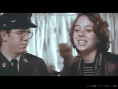 Rafferty and the Gold Dust Twins - Frisbee Mackenzie Phillips and Alan Boone Charlie Martin Smith at hotel desk and woman holding torbie cat animated gif