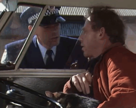 Rafferty's Rules - Unaired Pilot - Rafferty Chris Haywood in van with calico tabby cat talking to policeman animated gif