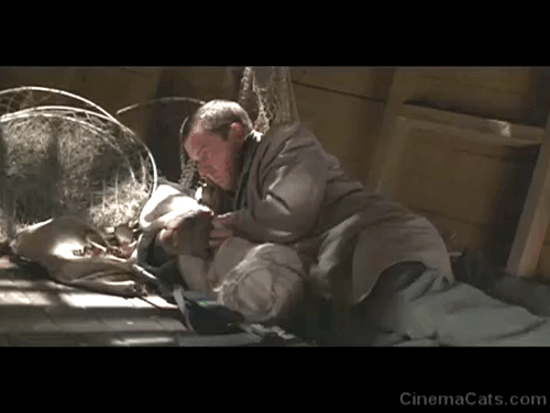 Savior - Guy Dennis Quaid with baby pushing orange and white tabby cat out of hold of boat to fool Croatian military leader animated gif