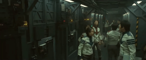 Space Battleship Yamato - Dr. Sado Reiko Takashima clinging to ginger and white tabby cat as crew runs around her animated gif